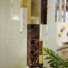 A collection of our pillar pendants, which combine sections of solid marble, fluted metal, and clear crystal. These substantial, high-quality fixtures can be hung individually or in clusters to create a dramatic effect in stairwells or entryways.