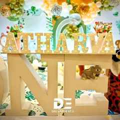 A giant 'ONE' prop with marquee letters spelling out the birthday boy's name. I often hide little themed details, like the small bear figure, within the props themselves.