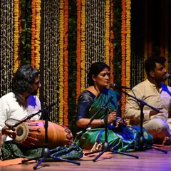 The live orchestra is an integral part of every performance. Here I am conducting the nattuvangam for Kavya Navani's arangetram, with the vocalist and mridangam player creating a rich musical tapestry.