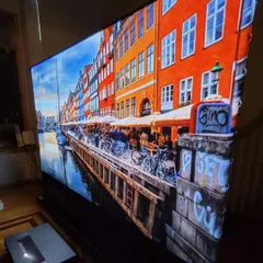 For living rooms and brighter spaces, we install ultra-short-throw (UST) projectors paired with ambient light rejecting (ALR) screens. This setup delivers a massive, vibrant 4K picture with excellent contrast and color, even without having to turn off all the lights.