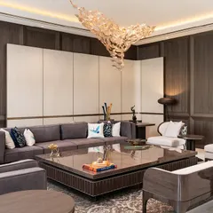 In this New Delhi farmhouse, we layered textures and forms to create a living space that is both warm and deeply sophisticated. The design features a custom wallpaper screen, Koto wood paneling, and a starburst-patterned center table, all harmonizing with the lush green views.