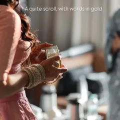 A quiet scroll with words in gold. This image captures the anticipation as the bride receives a special message just before the ceremony begins.
