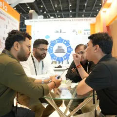 A group of professionals engaged in a focused meeting at a booth, demonstrating how the expo serves as a platform for strategic business discussions and planning.