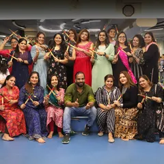 Our Navratri celebration, with everyone dressed in traditional attire and holding dandiya sticks. The spirit of community is strong here.