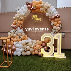 A slightly different angle of the elegant 31st birthday decoration, showing the full scope of the balloon arch on the lawn.