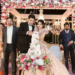 The cake cutting is such a special moment. I love ensuring the decor around it is just as sweet, with the floral stage creating a beautiful frame for the couple's celebration.