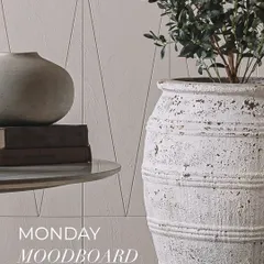 A large, white, rustic planter with a distressed finish, showcasing how we use such pieces to add character and a biophilic touch to our interiors.