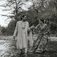 Who says you can't be adventurous on your wedding day? Nikita and Sachin were brave enough to step into the ice-cold Ganga river in Rishikesh for their portraits. This black and white photograph captures their playful spirit and the beautiful madness of their love story. These are the unique, candid wedding photos I love creating.