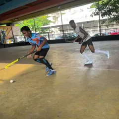 A defender closely marking an attacker. Rink hockey is all about these intense, one-on-one situations that test a player's defensive and offensive skills.