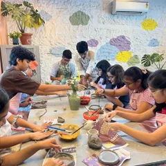 Our studio is always buzzing with creative energy, especially during our kids' workshops. Here, a group of young artists are busy with a hand-building project, each one focused on their unique creation.