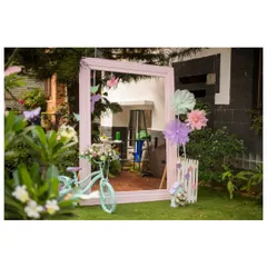 Another angle of the garden party photo booth, showing how the props are arranged to create a beautiful and inviting space for guests to take pictures.
