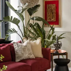A close-up of the living area, showing how we layered textures and objects. The embroidered cushions, bronze sculpture, and framed antique textile create a rich, collected feel.