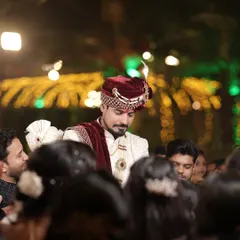 A candid shot of the groom amidst the crowd, his expression a mix of excitement and emotion.