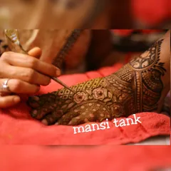A close up of me working on an intricate floral pattern on a bride's foot. I pay close attention to every detail to ensure the design is flawless.