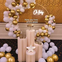 An elegant "Oh Baby" setup with a white and gold balloon arch, perfect for a sophisticated baby shower.