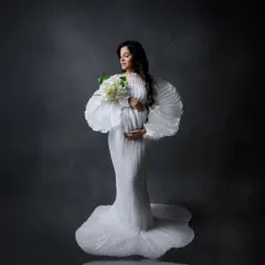 A portrait of strength, grace, and anticipation. In the studio, we use dramatic lighting and elegant gowns from my collection to create timeless images that celebrate your journey to motherhood.