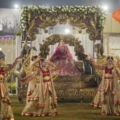 I believe a bride's entrance should be nothing short of majestic. Here, I crafted a royal arrival on an ornate palanquin, surrounded by dancers and a path of ethereal smoke, making her first appearance as a bride truly unforgettable.