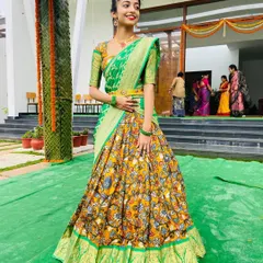 This is where tradition meets a bit of fun. I created this custom Kalamkari half saree, pairing the intricate printed skirt with a bright green blouse and a contrasting Banarasi georgette dupatta for a truly unique and festive langa voni.