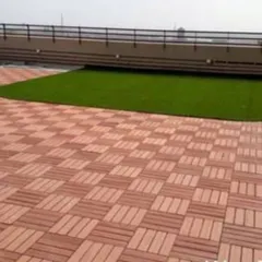I also install durable WPC (Wood Plastic Composite) deck tiles. They are a great, weather-resistant alternative to real wood and pair perfectly with artificial grass on rooftops and balconies.