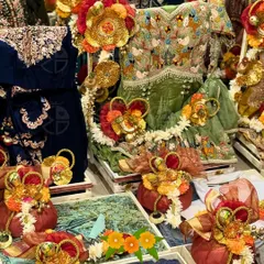 A vibrant display of traditional trousseau packing. Here, I've used rich green and red fabrics with intricate gota patti and floral embellishments to wrap bridal wear, creating a stunning visual for the gift presentation ceremony.