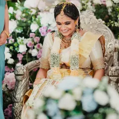 A joyful, candid moment from a client's baby shower. She is glowing in an off-white Kanchivaram saree and a custom hand-embroidered blouse I designed for her.