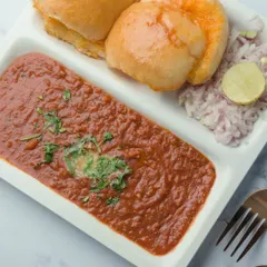 Here is our delicious Pav Bhaji, plated and ready to be served. The rich texture and vibrant color show the quality and care we put into this classic Mumbai dish.