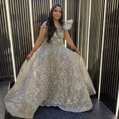 This client is glowing in a silver-grey ball gown with all-over sequin work. It’s a fairytale dress, perfect for a reception or engagement party.