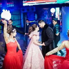 The couple's grand entrance at their cocktail party, complete with professional dancers and dramatic lighting, creating a truly spectacular moment.