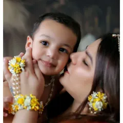 A close-up from a themed Janmashtami photoshoot, capturing a mother's affectionate kiss. I provide costumes and props to make these festive sessions special and authentic.