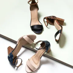 A dynamic and creative composition of heeled sandals. The angled placement and clean background create a modern, architectural look that is more engaging than a standard product shot.