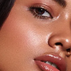 An extreme close-up macro beauty shot. This image highlights incredible detail, from the texture of the skin to the glossy finish on the lips, demonstrating a high level of technical skill in retouching and photography.