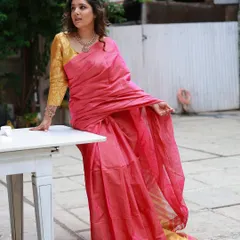 A full-length shot showing the beautiful drape and texture of the linen saree. The styling is simple and elegant, letting the quality of the fabric speak for itself.