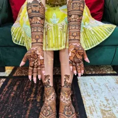 Another angle of a full bridal mehandi set, showing how the peacock and elephant motifs are carried from the arms down to the feet.