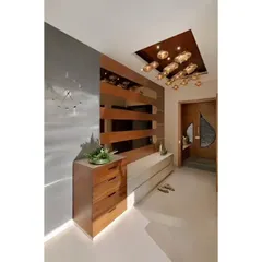 A close-up of a modern foyer with a wooden chest of drawers and a sleek white console table against a grey wall with a wooden partition.