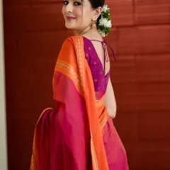 "ಕನಸಲ್ಲು ನೀನೆ." You are in my dreams. A simple yet elegant portrait capturing a candid glance over the shoulder. The focus is on the traditional saree and the simple beauty of the moment.