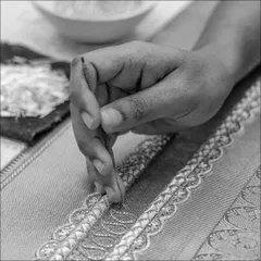The delicate process of hand-embroidery, where every bead and thread is placed with precision and artistry.