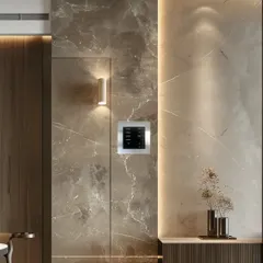 A Rako modular keypad installed on a marble-tiled wall, showcasing how our systems integrate seamlessly into high-end interior finishes. The keypad provides customizable control while enhancing the room's sophisticated design.