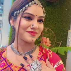 A close-up of a model wearing a full set of oxidized silver jewellery, including a choker, matha patti, and hath phool. This bohemian style is perfect for Navratri.