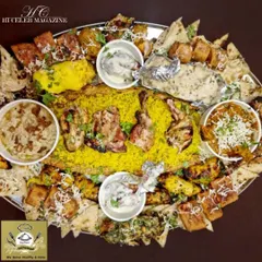A closer look at one of my signature thaals. You get a bed of fragrant rice surrounded by different chicken preparations, from creamy malai tikkas to spicy tandoori pieces, along with gravies and naan.