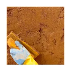 Applying the final coat of 'Thappi' lime plaster. The beauty of this technique lies in its natural, earthy finish and the hands-on process of its creation.