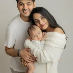 A classic first family portrait. I love the simplicity of the all-white outfits, which keeps the focus on the family's loving connection and their beautiful baby.