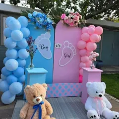 A classic 'Boy or Girl' backdrop perfect for any gender reveal party. This setup uses pink and blue arched panels, matching balloon columns, and cute teddy bears to create a sweet photo opportunity.