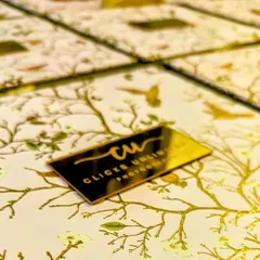 A customized brand identity box for an ace photographer. The box features a beautiful floral print and a gold acrylic logo, creating a memorable and thoughtful gift for their clients.