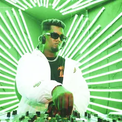 In the zone behind the decks, surrounded by neon lights. I focus on mixing the perfect track to match the club's energy, ensuring a seamless flow of music.