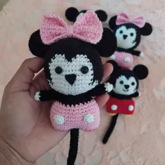 A close-up of a handmade Minnie Mouse toy, showing the detailed stitching on her face and her signature pink bow. These are so soft and perfect for little hands to hold.