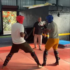 A moment during a sparring drill, focusing on footwork and maintaining a strong defensive stance. These fundamentals are crucial in MMA.