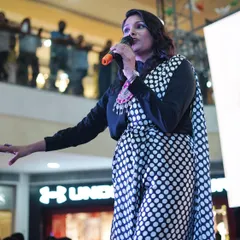 A powerful shot of me on stage at the Pacific Mall in Dehradun, hosting the Global Village festival. I am confident and command attention in any setting.
