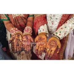A beautiful shot of the bride and groom showcasing their mehndi. Her hands tell their story with portraits, while his features minimalist traditional symbols. This is what a complete couple's package looks like.