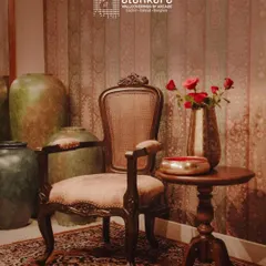 The Murano Kursi, an antique-style chair I crafted, inspired by tradition but designed for today. It features ornate carvings, a cane back, and plush seating.