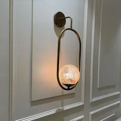 We love designing custom elements, like this wall light with a globe made of stained glass mosaic. It casts a unique, warm light and acts as a piece of art on the wall.